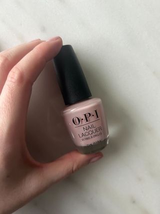 OPI put it in neutral nail polish on a marble table