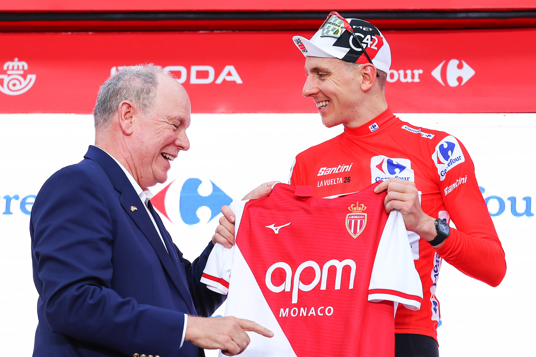 MONACO, MONACO - AUGUST 22: (L-R) Albert II, Prince of Monaco and Tadej Pogacar of Slovenia and UAE Team Emirates XRG celebrates at podium as stage winner and pose in the Monaco Football Club jersey during the La Vuelta - 81st Tour of Spain 2026, Stage 1 a 9.4km individual time trial stage from Monaco to Monaco / #UCIWT / on August 22, 2026 in Monaco, Monaco. (Photo by Alexander Hassenstein/Getty Images)