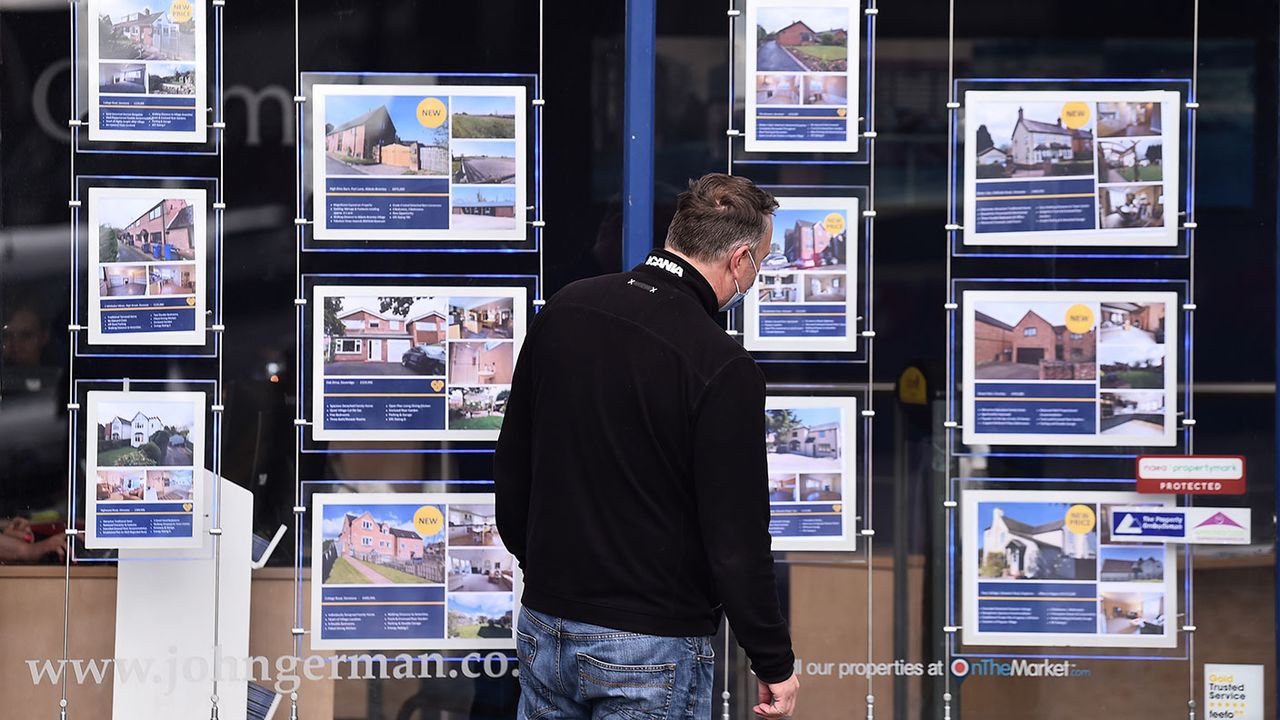 Man looking in an estate agent&amp;#039;s window