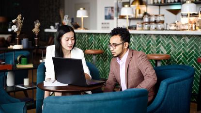 A financial planner meets a client in a restaurant.