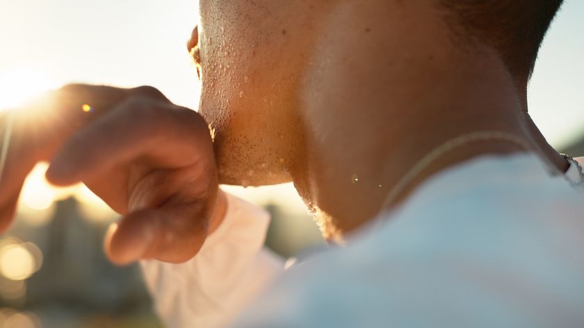 a close-up of the back of a man&#039;s head as he wipes sweat off his face