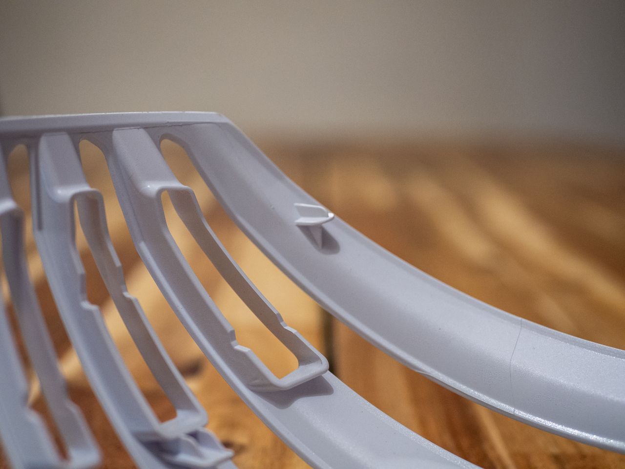 A white Uvex Surge helmet stands on a wooden table