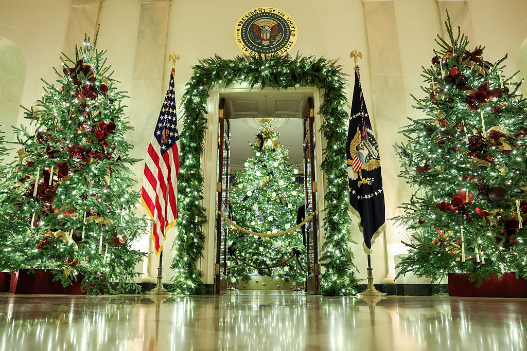 red decorated christmas trees in the white house cross hall