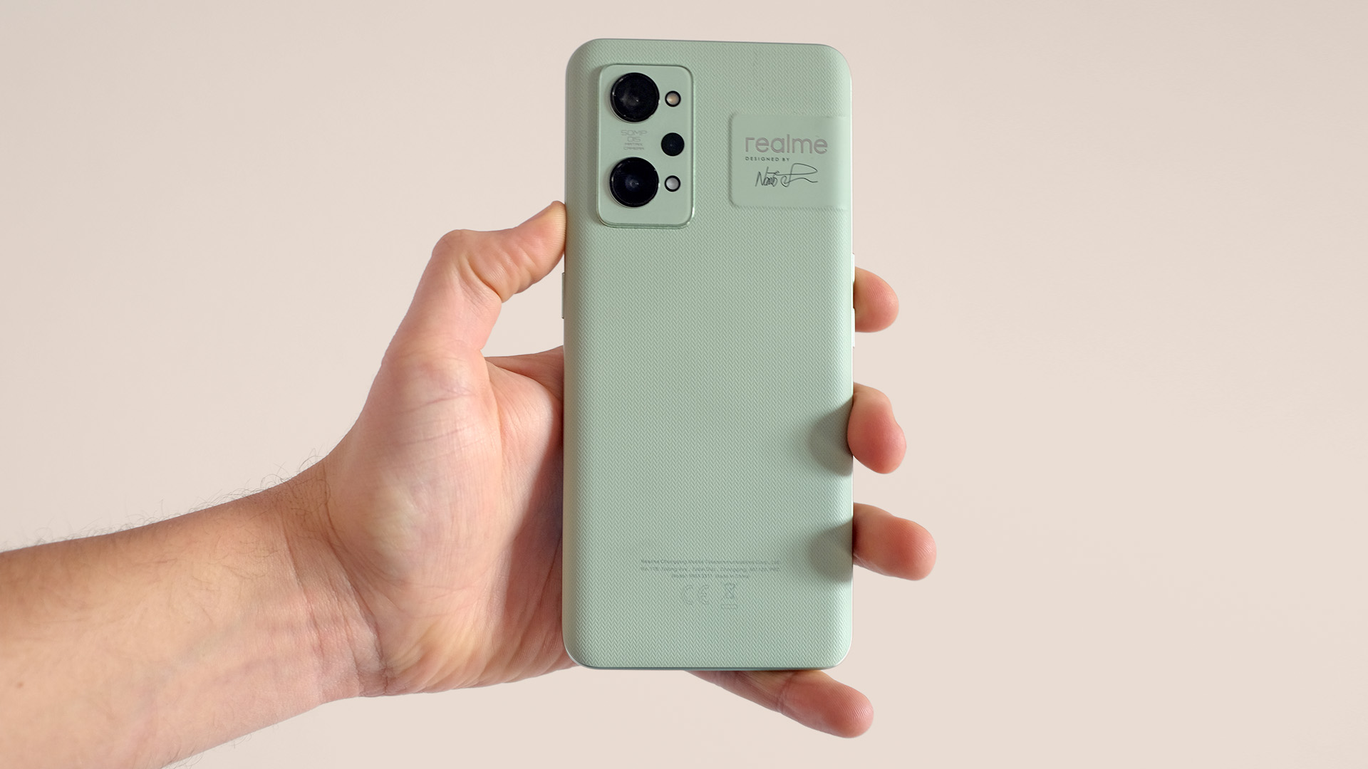 A Realme GT 2 from the back, held in someone's hand