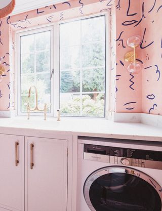 a laundry room with bold wallpaper