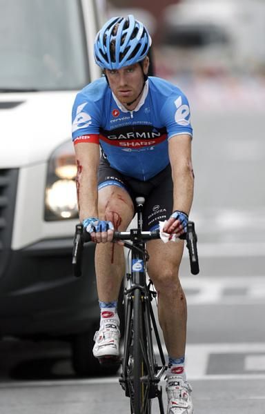 Tyler Farrar (Garmin-Sharp), battered and bloodied from a crash in the stage 5 finale, crosses the finish line in Saint-Quentin.