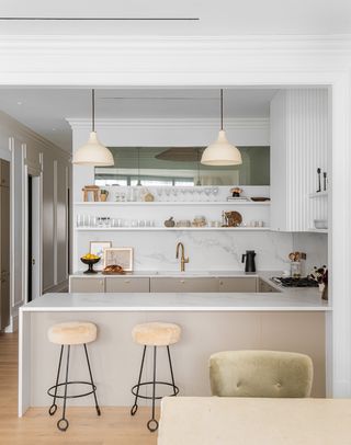 neutral kitchen with grey island and counter stools