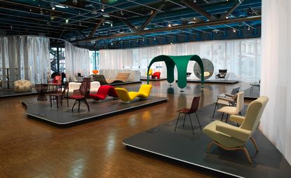 Showroom in the Centre Pompidou with wooden floors and black stages with chairs and sofas on display