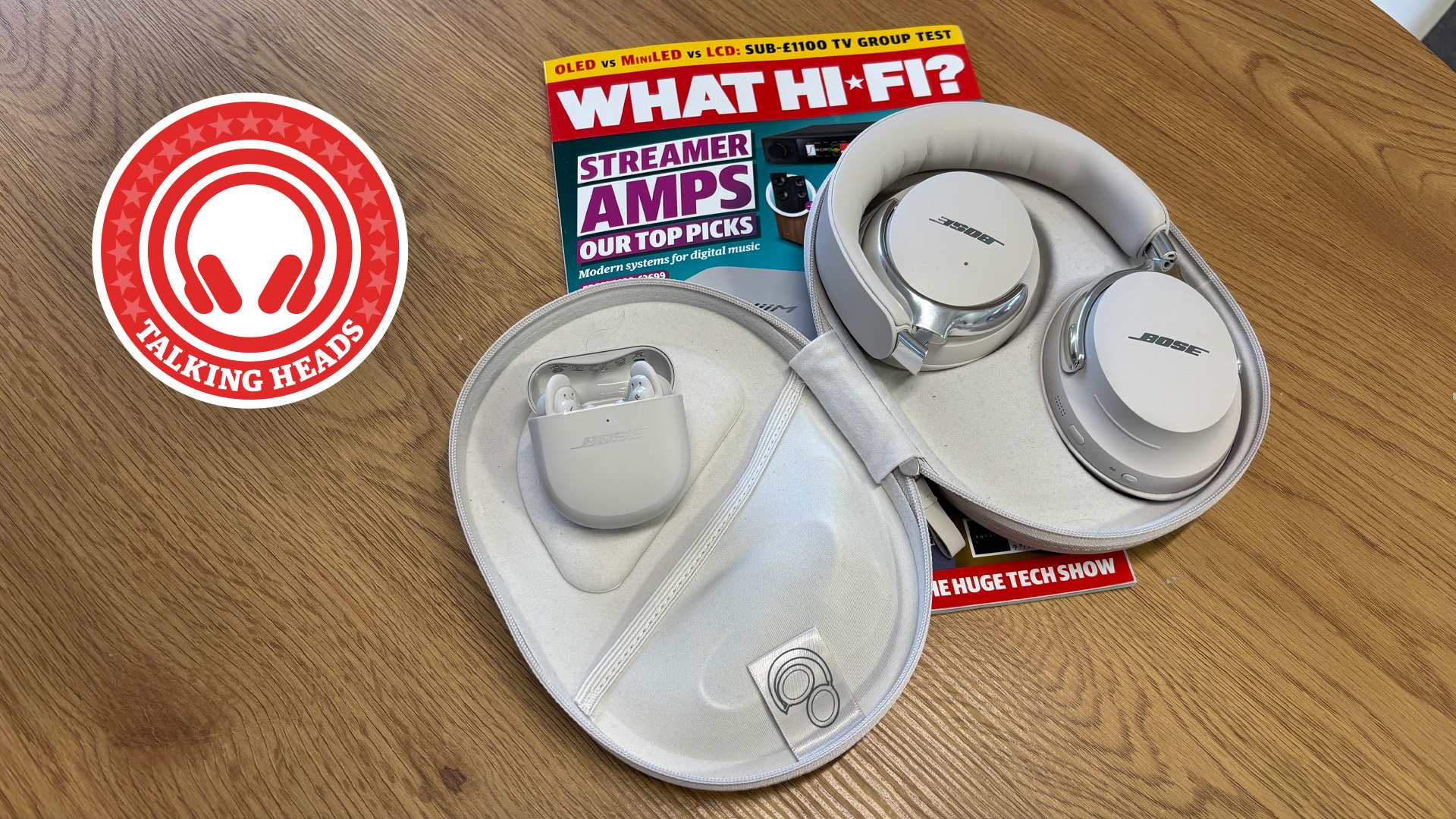 Bose QC Ultra earbuds and headphones in their cases on a copy of What Hi-Fi? magazine on a table