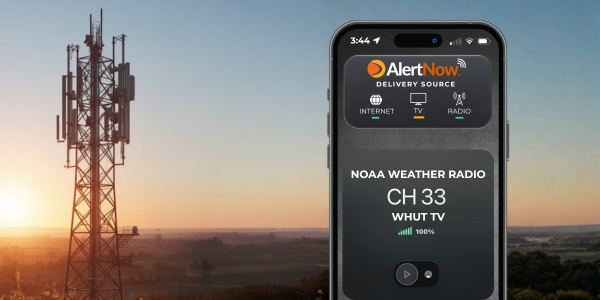 NOAA Weather Radio with a transmitter in the background.