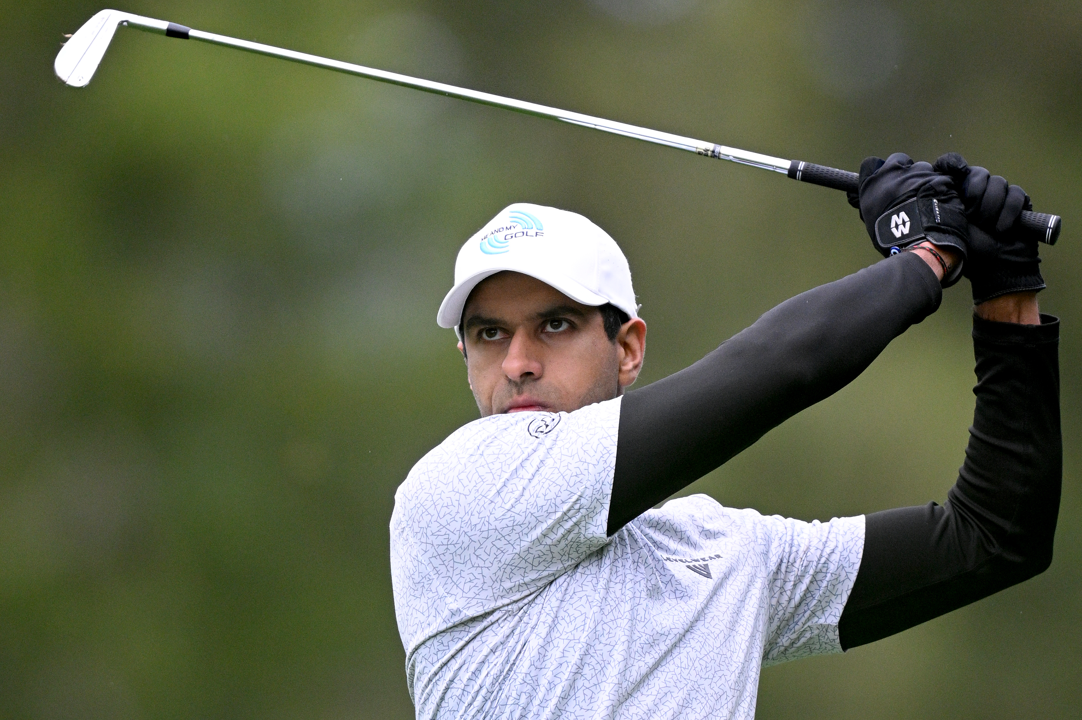 Aaron Rai watches an iron shot into the green