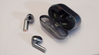 Samsung Galaxy Buds 3 Pro with their case, on a table