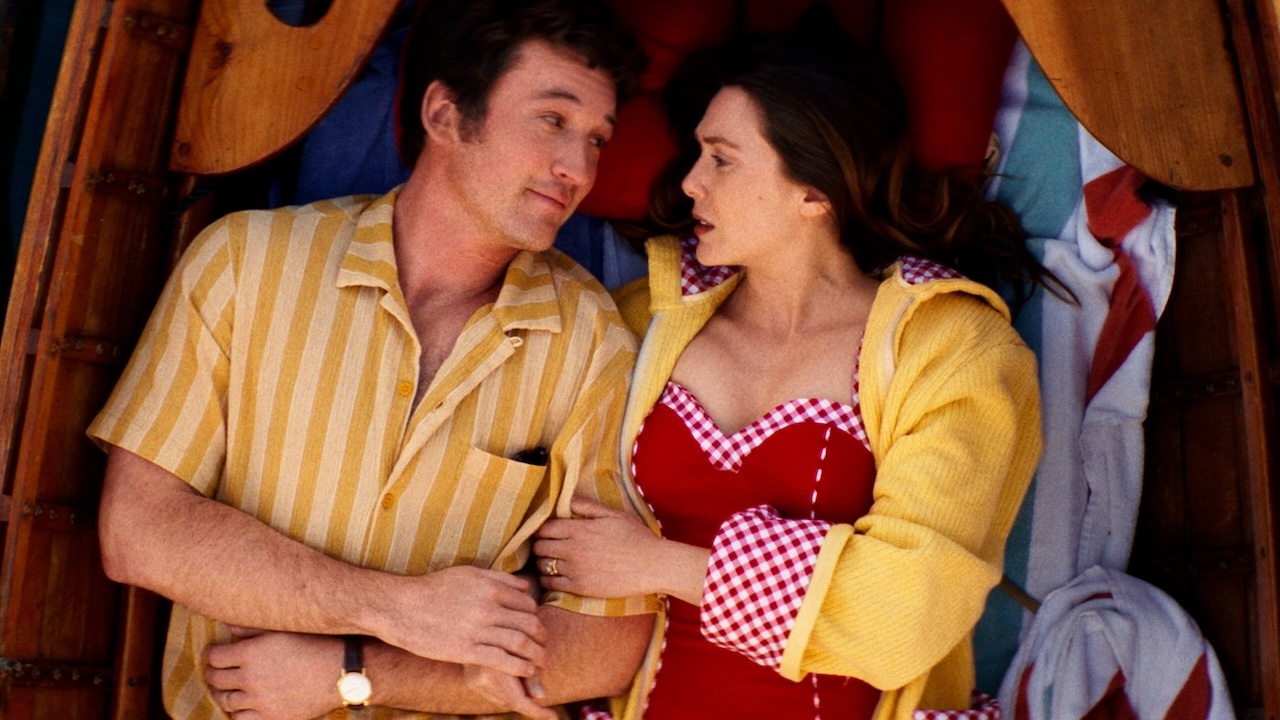 Miles Teller and Elizabeth Olsen laying in a rowboat in Eternity