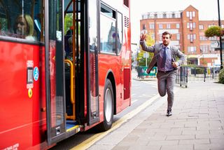 Man running to catch a bus.