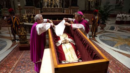 Former personal secretary of Pope Benedict XVI Archbishop Georg Gänswein poses a veil on the Body Of Pope Emeritus Benedict XVI as it is laid to rest in his coffin 