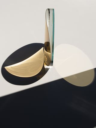 A round glass shape balanced on a table