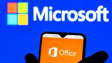 Microsoft Office app logo pictured on a smartphone screen with Microsoft logo and branding in background.