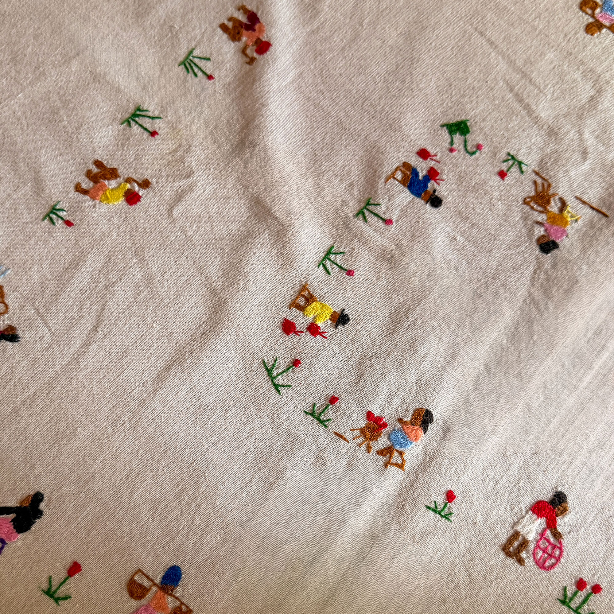 Fabric embroidered with people and flowers