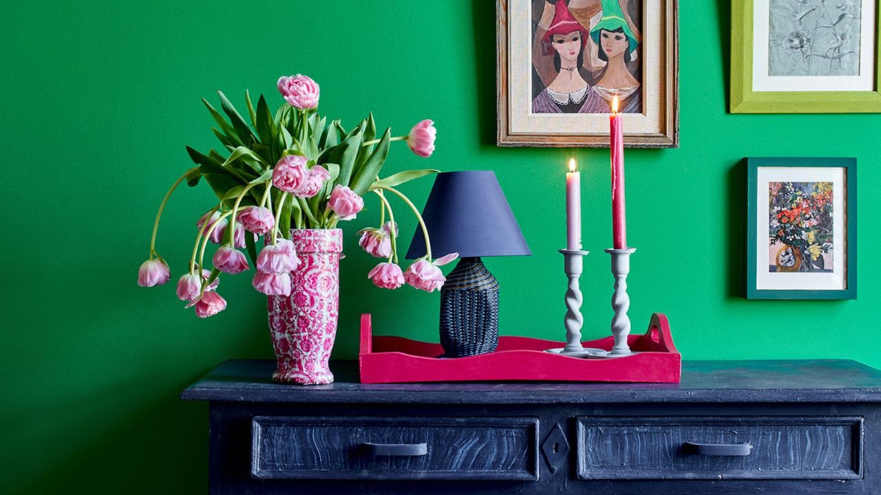 Green wall, blue console, pink tray