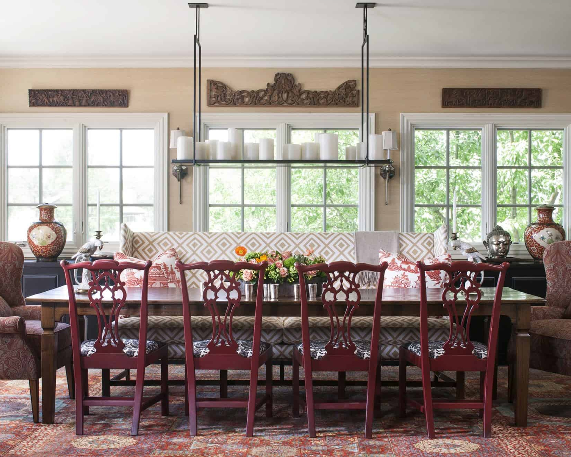 Red dining room area in traditional style with printed rug