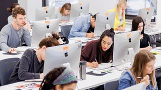 Rows of students working away on Macs