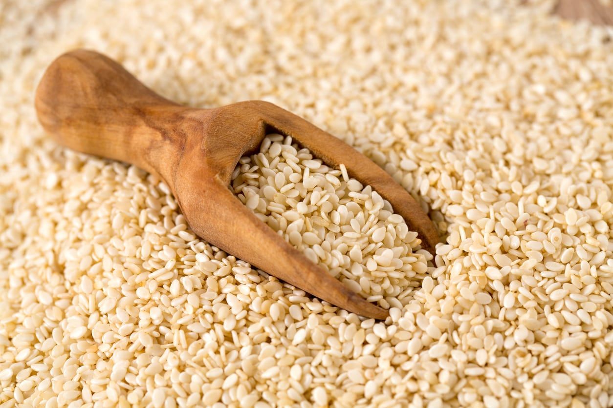 Wooden Spoon Surrounded By Sesame Seeds