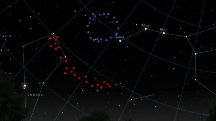 A view of the sky with one dotted blue circle toward the top center and a dotted red art to the middle left.