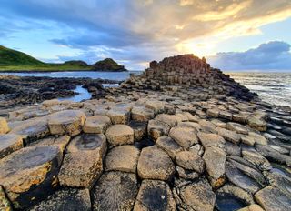 The Giant's Causeway with links on the water is a popular tourist attraction in Northern Ireland