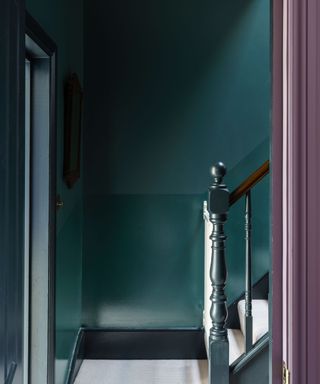 Dark blue-green painted hallway and stairway