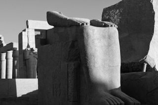 Temple of Rameses, stone blocks with temples in the backdrop.
