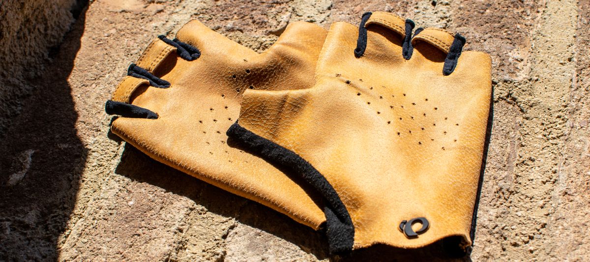 A pair of Pearl Izumi Pro Air mitts on a brick wall 