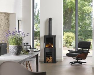 E NEO3C stove by ACR Stoves with chair in open plan kitchen with views of garden