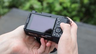 Sony ZV-E1 digital camera rear screen held in hands