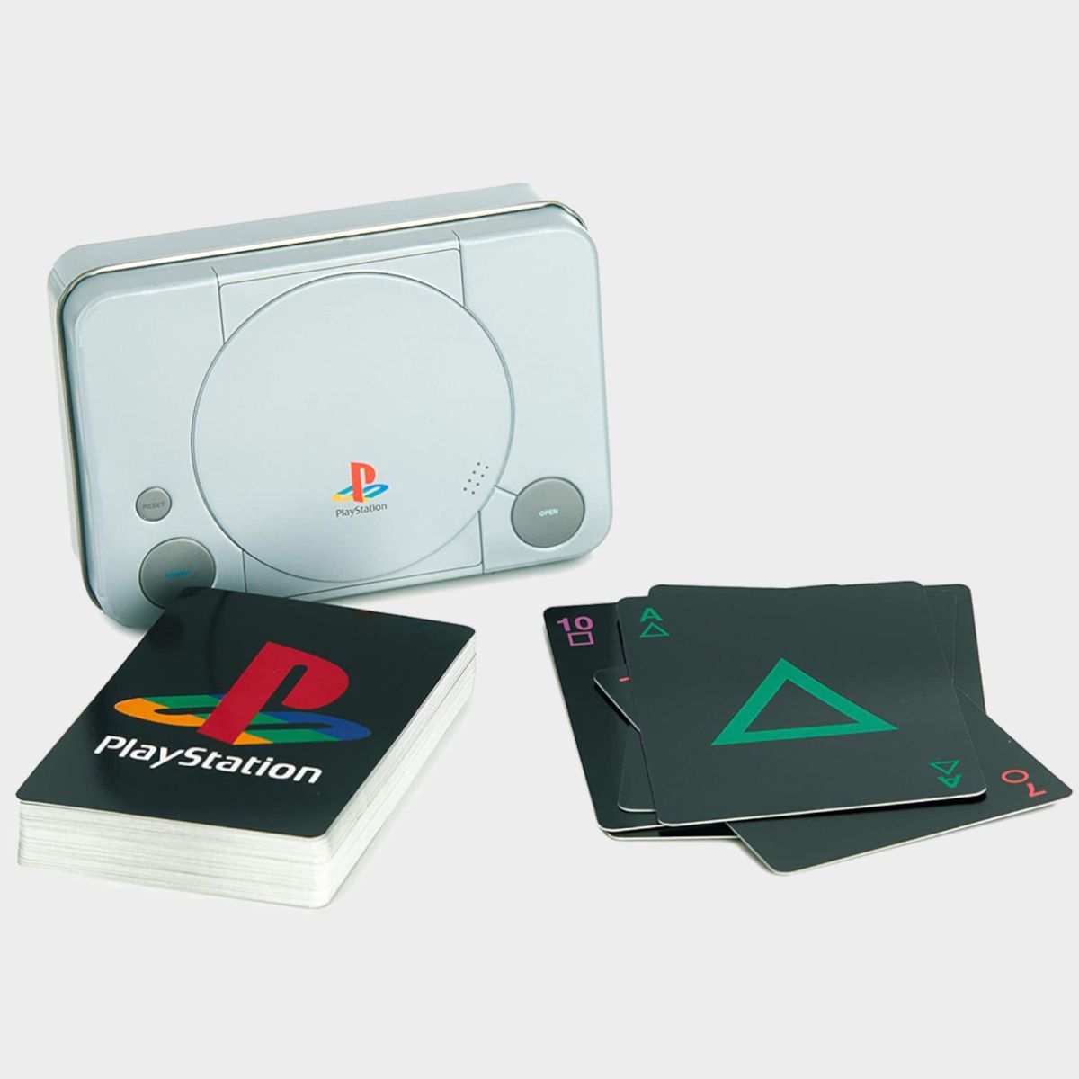 PlayStation Playing Cards and PS1 tin on a plain background