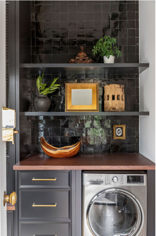 Dark tile laundry room with shelving