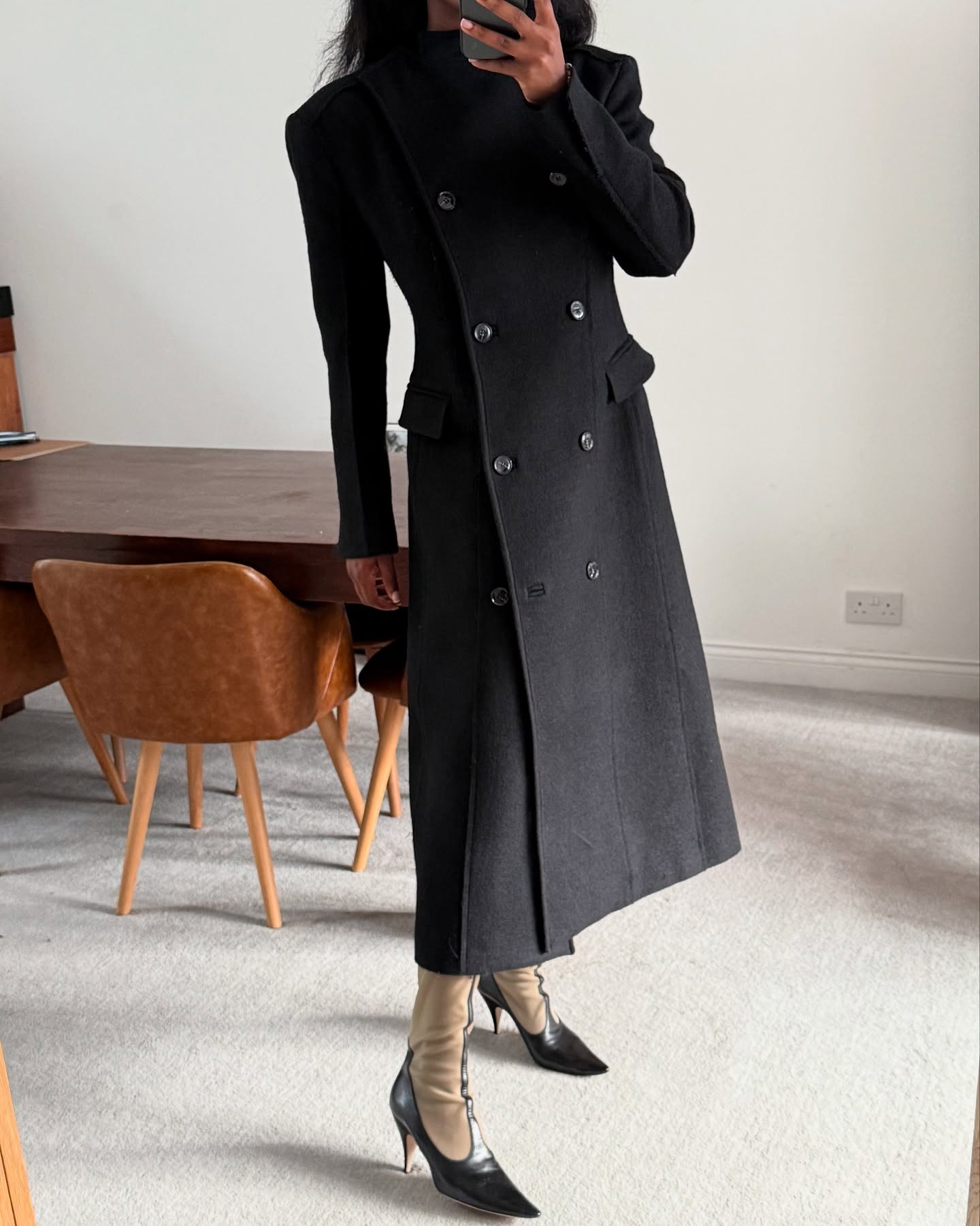 @nlmarilyn wearing a double-breasted coat with The Row&#039;s mesh boots.