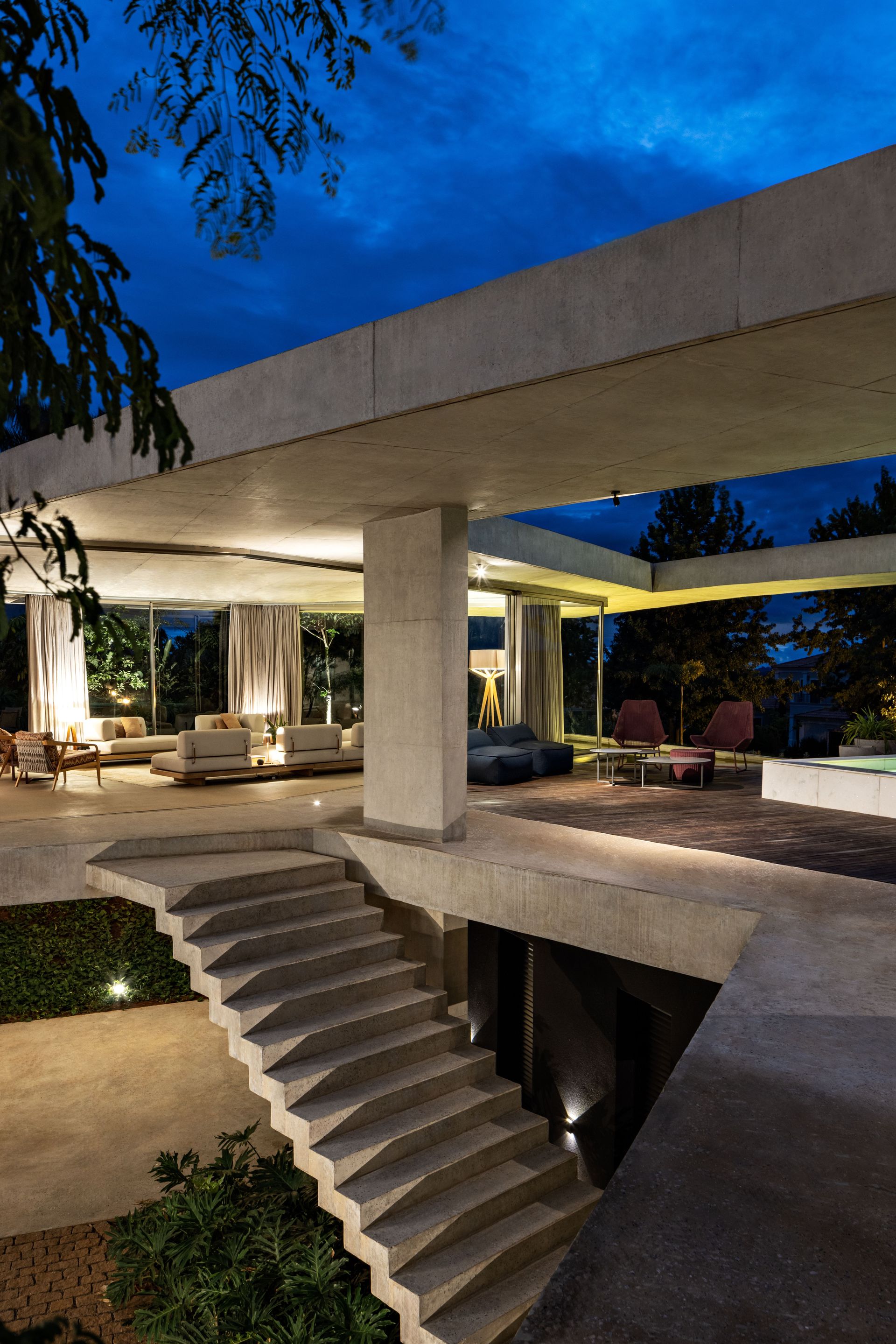 Casa Subtração at dusk with a close up of the stairs