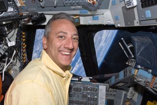 NASA astronaut Mike Massimino, STS-125 mission specialist, occupies the commander’s station on the flight deck of the Space Shuttle Atlantis on May 19, 2009.