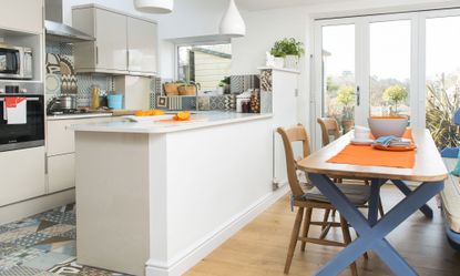 kitchen room with white walls kitchen cabinets and wooden table with chairs