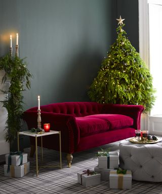 Christmas tree with red couch in front