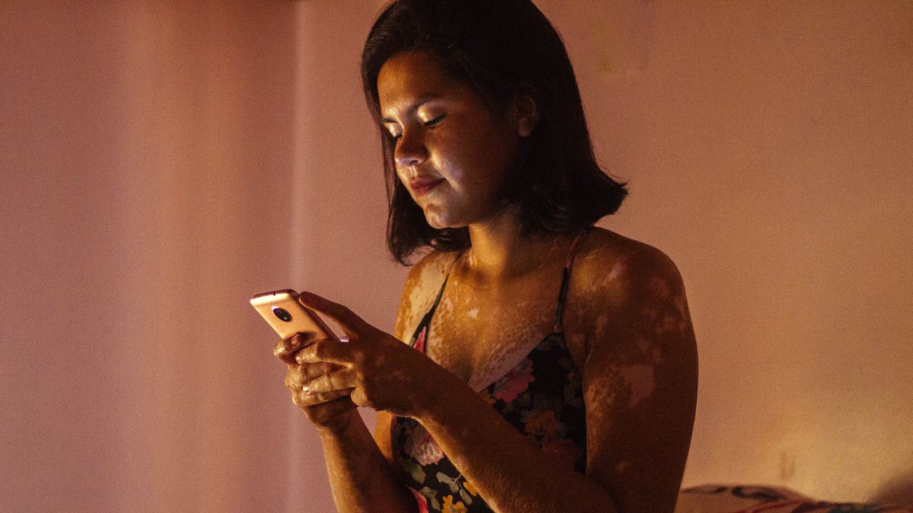  Woman typing on her phone - stock photo