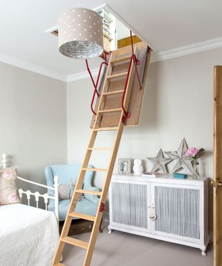 room with white wall and wooden ladder