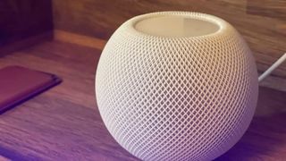 White Apple HomePod mini sitting on a table