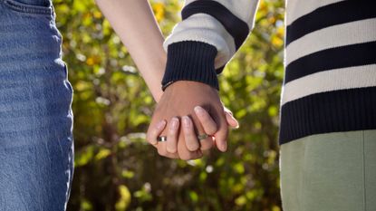 A stock image of a couple holding hands. 