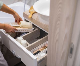 An open bathroom drawer with organizers