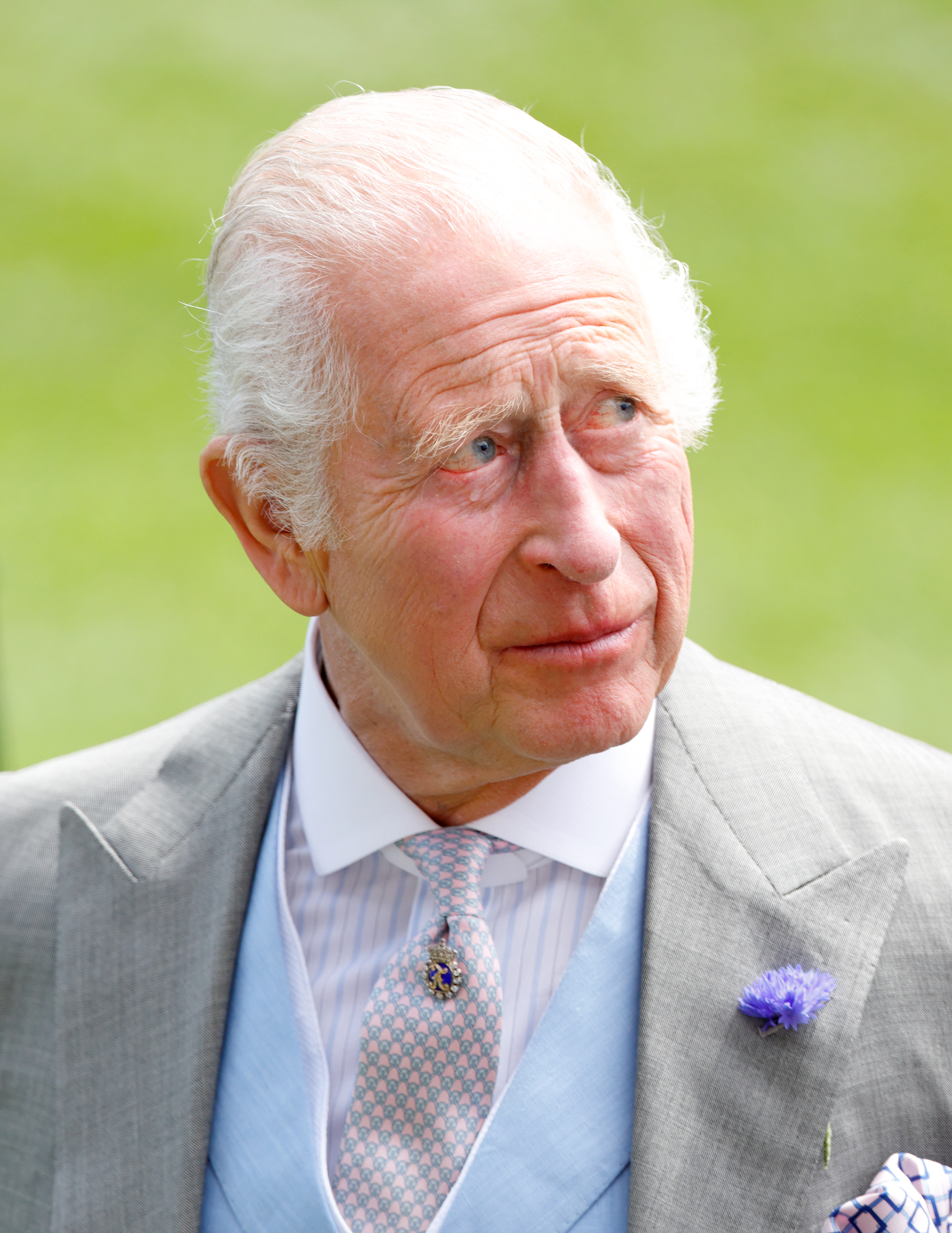 King Charles in a gray suit looking to the right