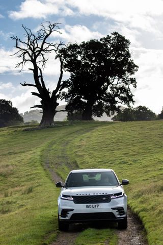 Range Rover driving across a field