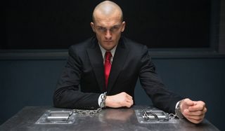 Hitman Agent 47 the Hitman handcuffed to a table