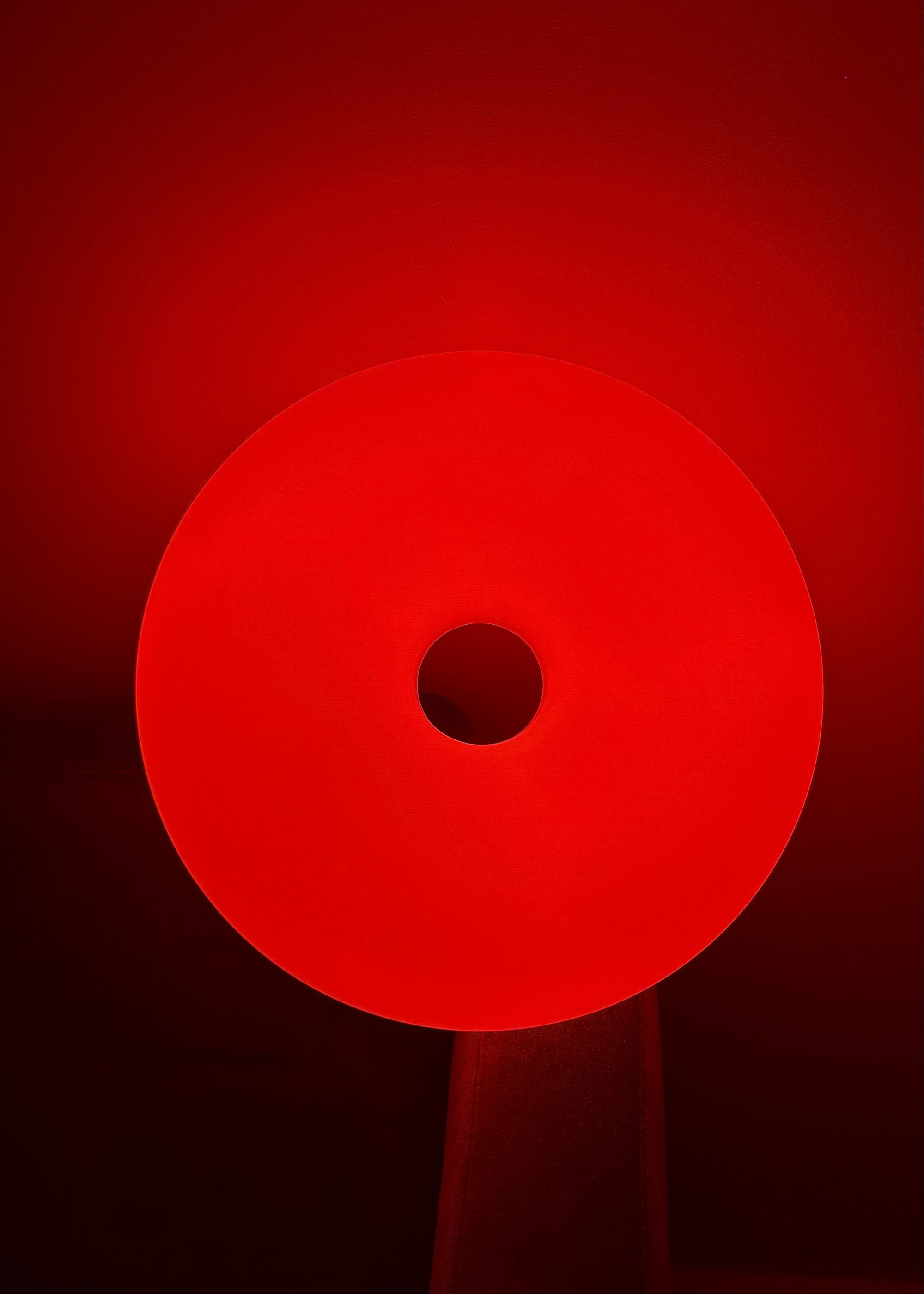 The IKEA VARMBLIXT donut lamp reflecting red light