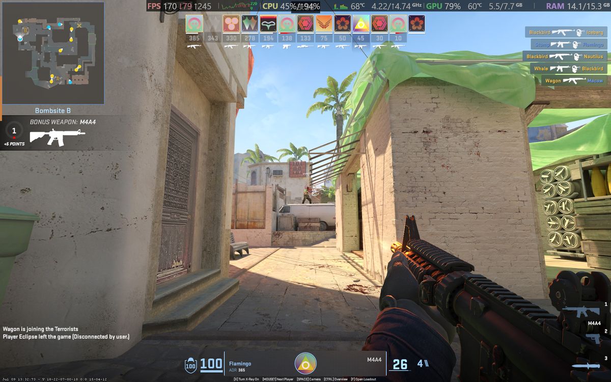 Counter-Strike 2 gameplay screenshot showing gunfights and UI elements running on an Alienware 15 laptop